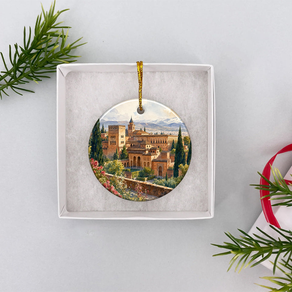 Round Alhambra travel ornament resting securely inside an opened white gift box ready for giving.