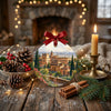 Festive ornament displayed on a rustic table alongside winter pinecones and a lit candle.