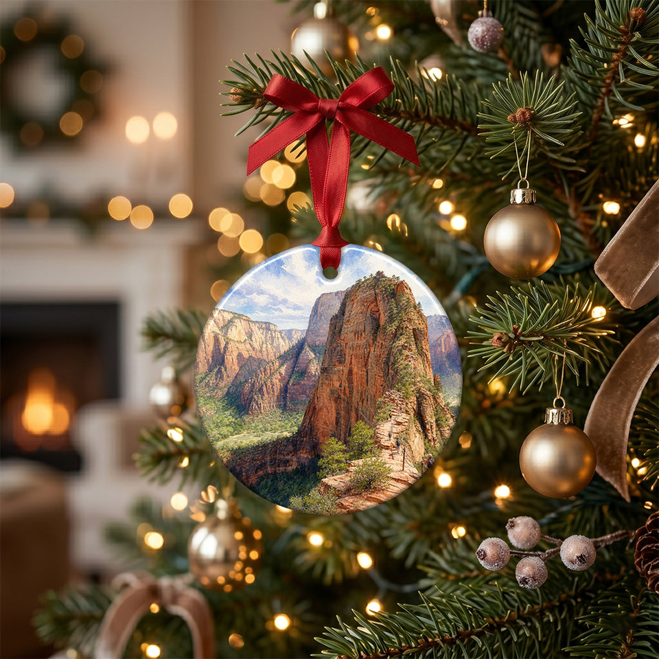 Zion National Park holiday keepsake hanging among glowing lights on an evergreen tree branch.