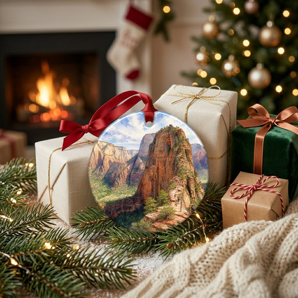 Round Utah travel ornament resting next to festive wrapped gifts by a warm holiday fireplace.