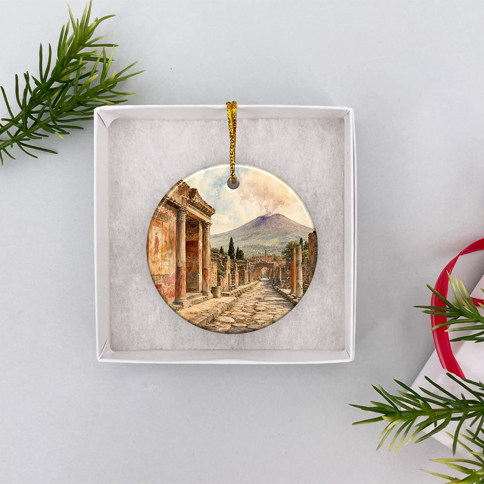 Open white gift box displaying the round ceramic Pompeii souvenir ready for holiday giving.