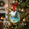 Ceramic Palawan holiday keepsake suspended from a brightly lit Christmas tree branch.