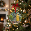 Ceramic holiday ornament hanging gracefully from an illuminated Christmas tree branch