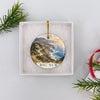 Two-sided Big Sur coastal ornament presented inside an open white gift box ready for Christmas giving.