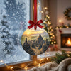 Round travel ornament hung before a frosty winter window catching gentle morning daylight.