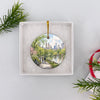 Round ceramic NYC holiday ornament presented neatly inside an opened white gift box ready for giving.