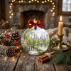 Festive ceramic holiday decoration arranged on a rustic table display with pinecone accents and a candle.