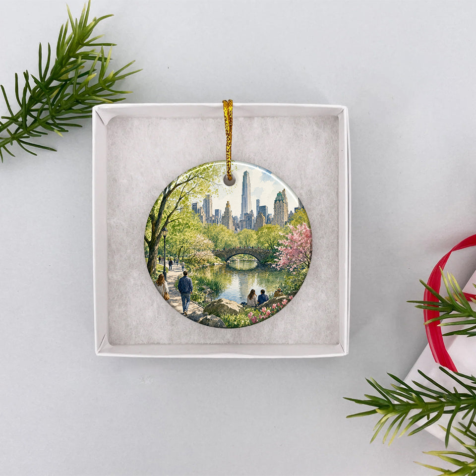 Round Central Park ornament presented inside an open white gift box.