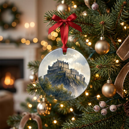 Festive Edinburgh ornament arranged on a rustic table alongside scented pinecones and a candle.