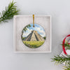 Round ceramic travel keepsake tucked inside an open white gift box ready for gifting.