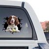 Vibrant dog sticker proudly showcased on the tinted rear glass window of a truck.