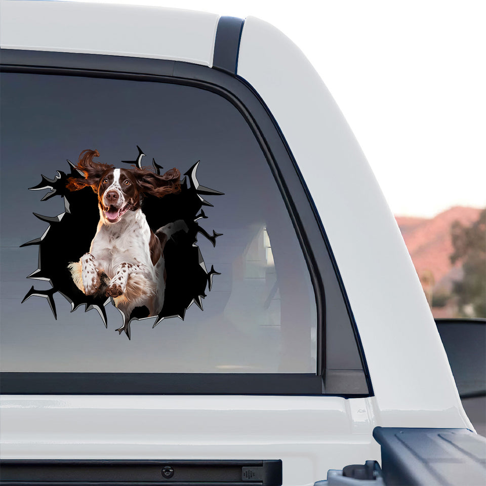 Realistic cracked glass spaniel decal displayed on the back glass of a truck.