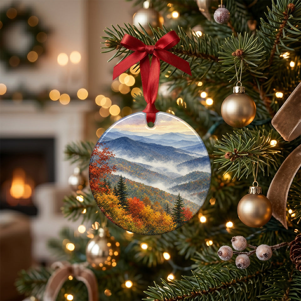 Smoky Mountains holiday ornament hanging from a branch on a lit Christmas tree.