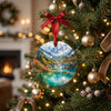 Ceramic Jiuzhaigou keepsake hanging from an evergreen tree branch beside warm glowing holiday lights.