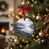 Scottish castle holiday ornament hanging from a festive Christmas tree branch with warm lights.
