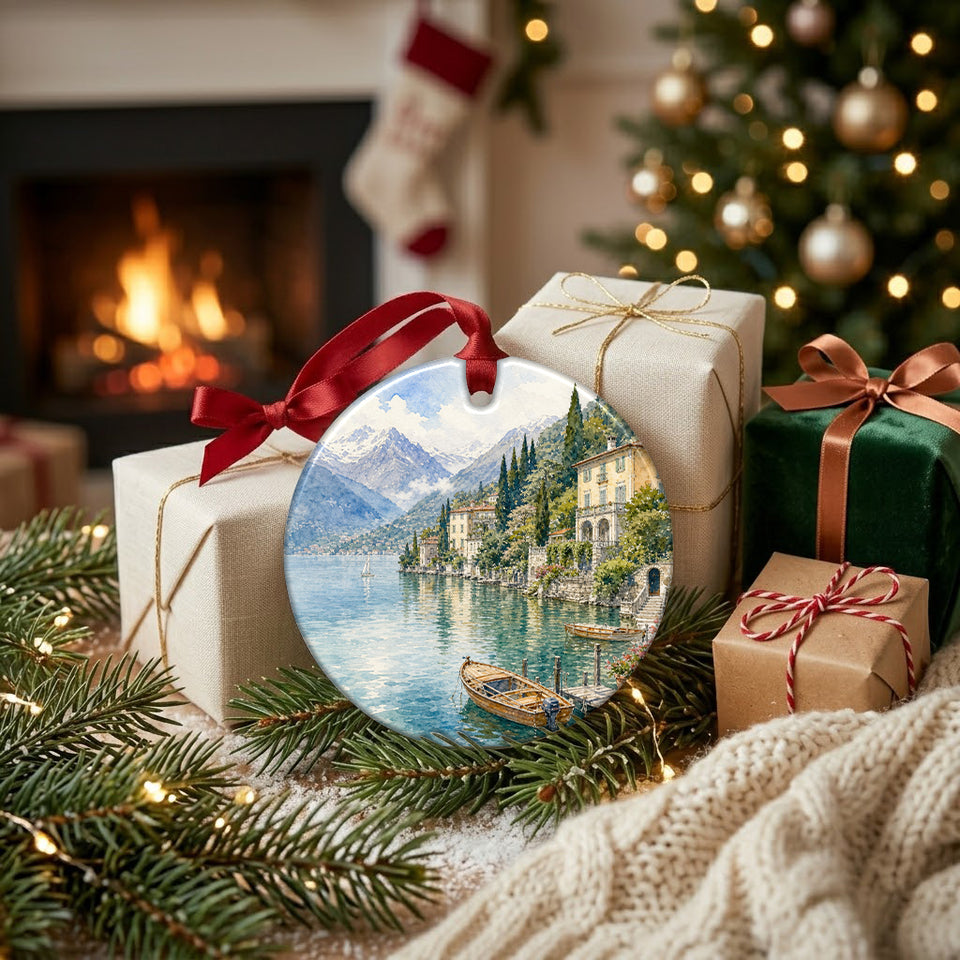 Holiday scene featuring the Lake Como ornament resting beside wrapped gifts near a fireplace.