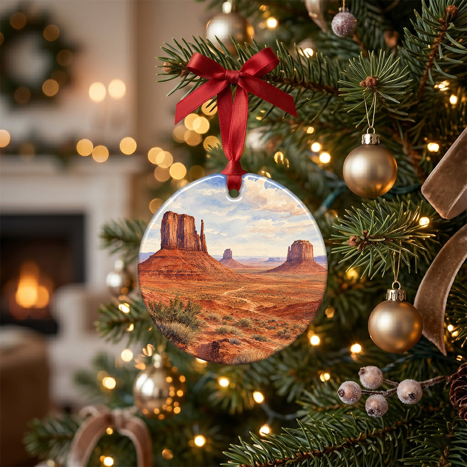 Ceramic travel keepsake hanging on a warm lit holiday tree branch.