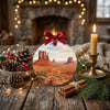 Round desert art ornament styled on a rustic holiday table with natural pinecones.