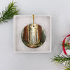 Round national park holiday ornament packaged neatly inside an open white gift box ready for gifting.