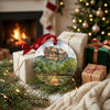 Round Sri Lanka keepsake ornament resting next to festive wrapped gifts in front of a warm fireplace.