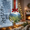 Festive alpine road ornament suspended in front of a frosty winter window catching gentle daylight.