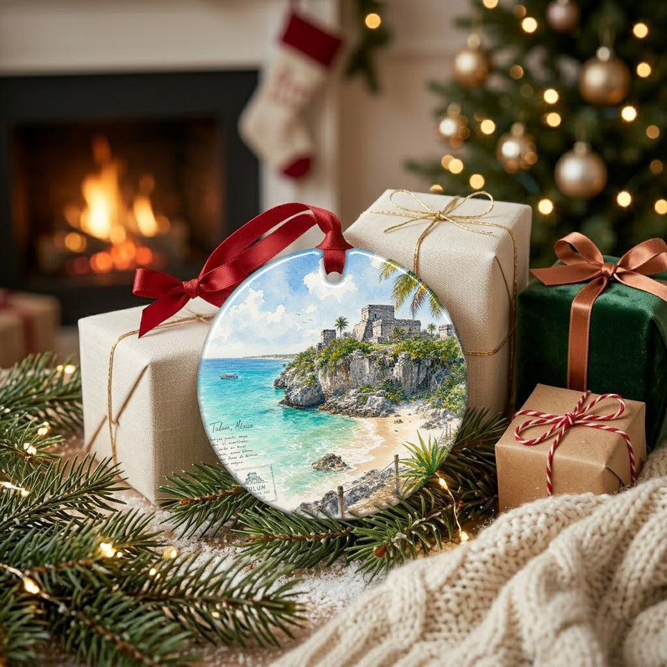 Festive coastal Mexico travel ornament arranged next to wrapped gifts beside a warm, glowing fireplace.
