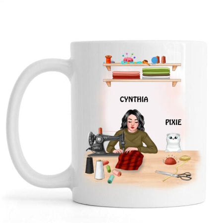 Cat sewing personalized mug in white ceramic featuring custom text and cat crafting artwork.